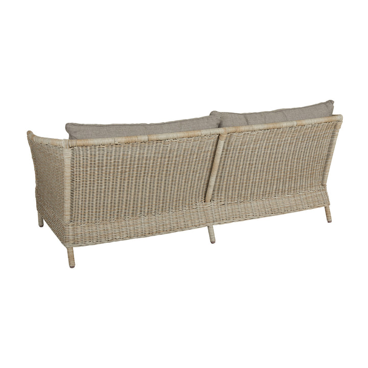 Brafab Aster utesofa i naturfarget kunstrotting, sett bakfra med beige puter