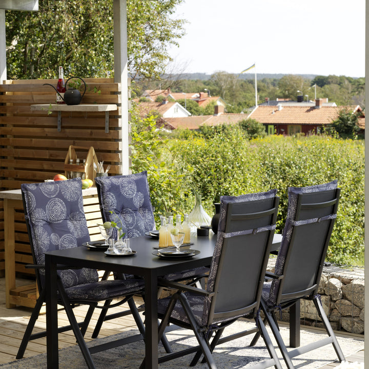 Brafab Rana spisestol i sort ved mørkt bord på terrasse med utsikt over hager og hus