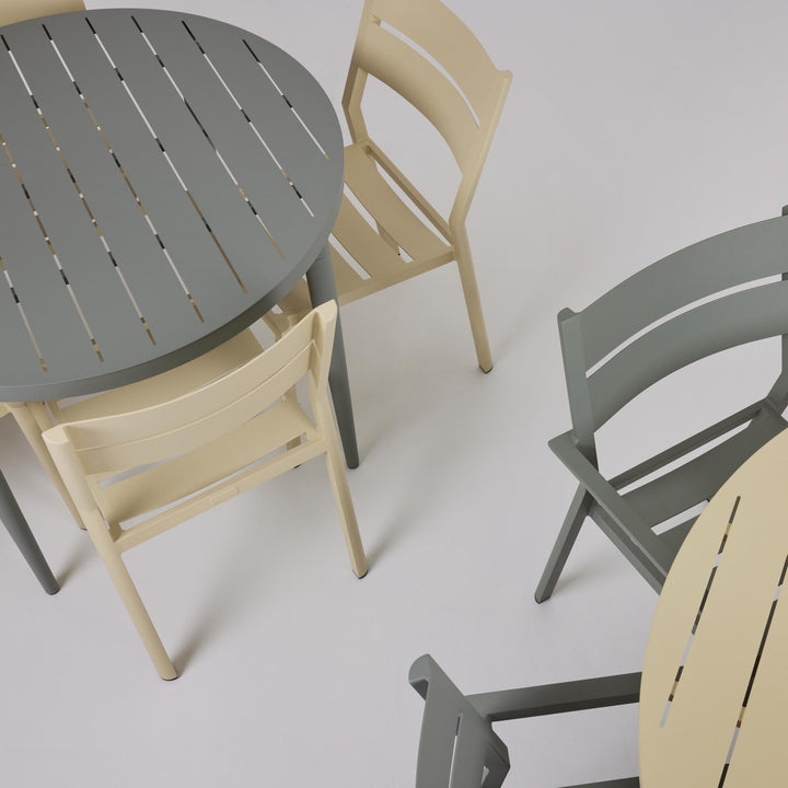 Brafab Delia spisestol uten armlene i lys gul ved grått bord med stoler, sett ovenfra