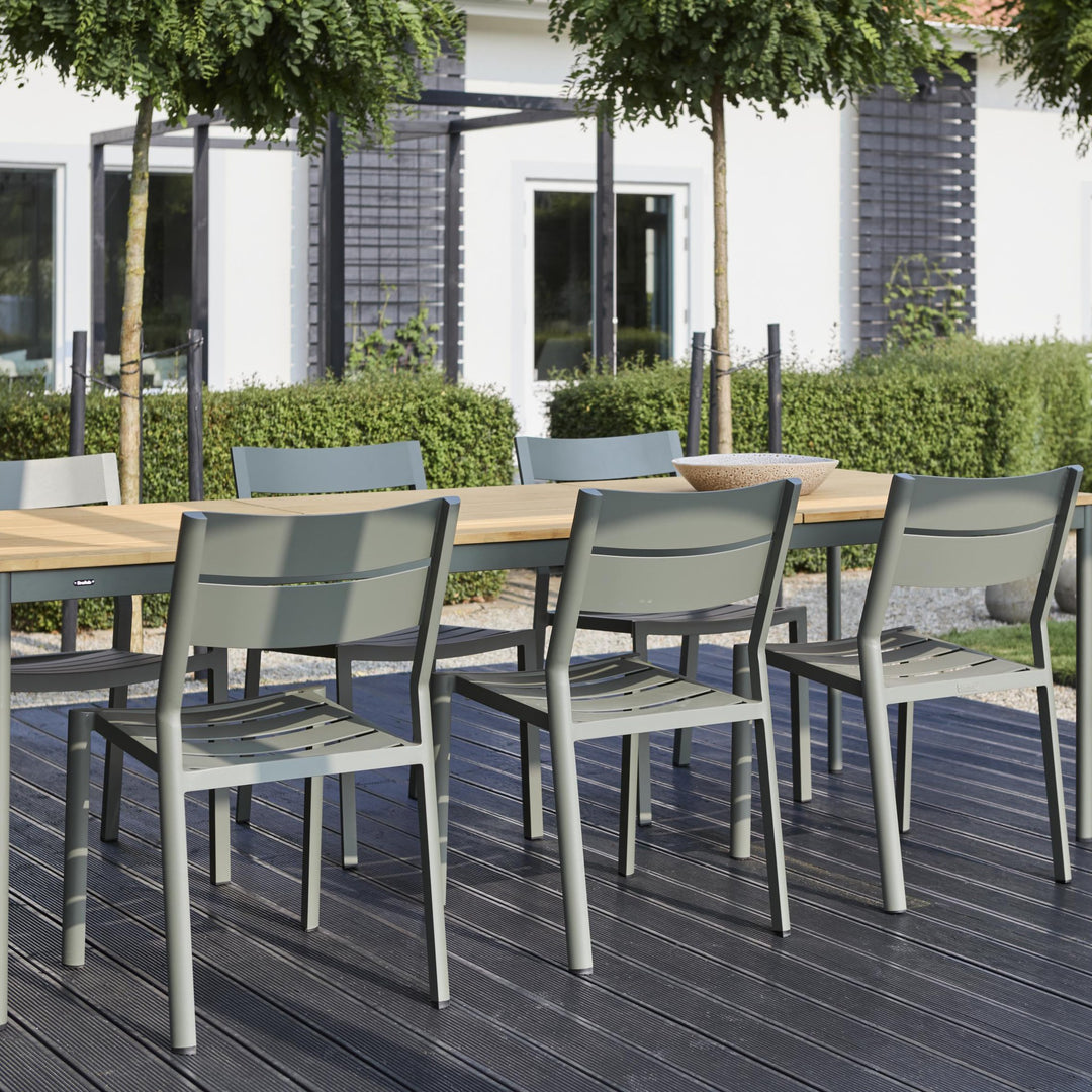Brafab Nox Bamboo spisebord med treplate og grønne stoler på mørk terrasse ved hvitt hus