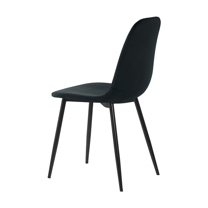 Trend spisestol i sort velur med sorte metallben, sett skrått bakfra mot hvit bakgrunn