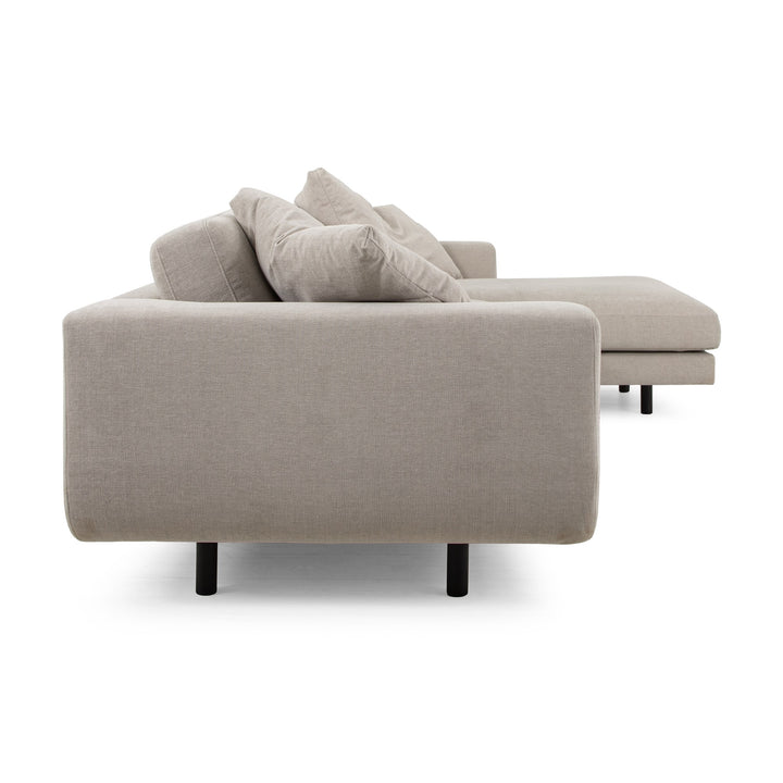 Lazy Sofa i kremhvitt stoff sett fra siden, med sjeselong og svarte ben