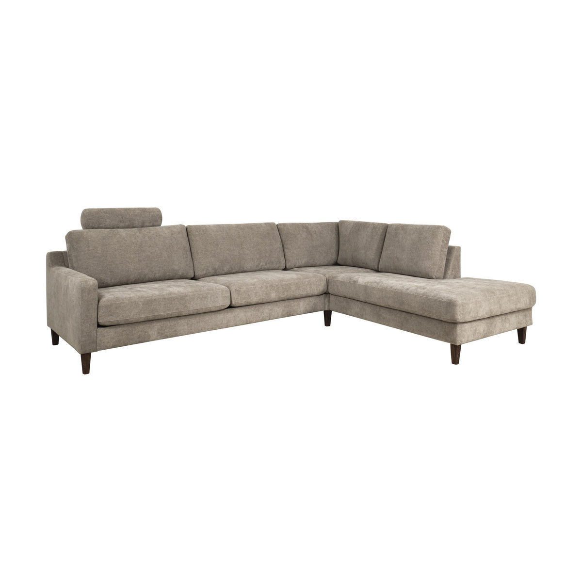 Hovden Scandinavian Touch nakkepute på gråbeige hjørnesofa, sett fra siden mot hvit bakgrunn.