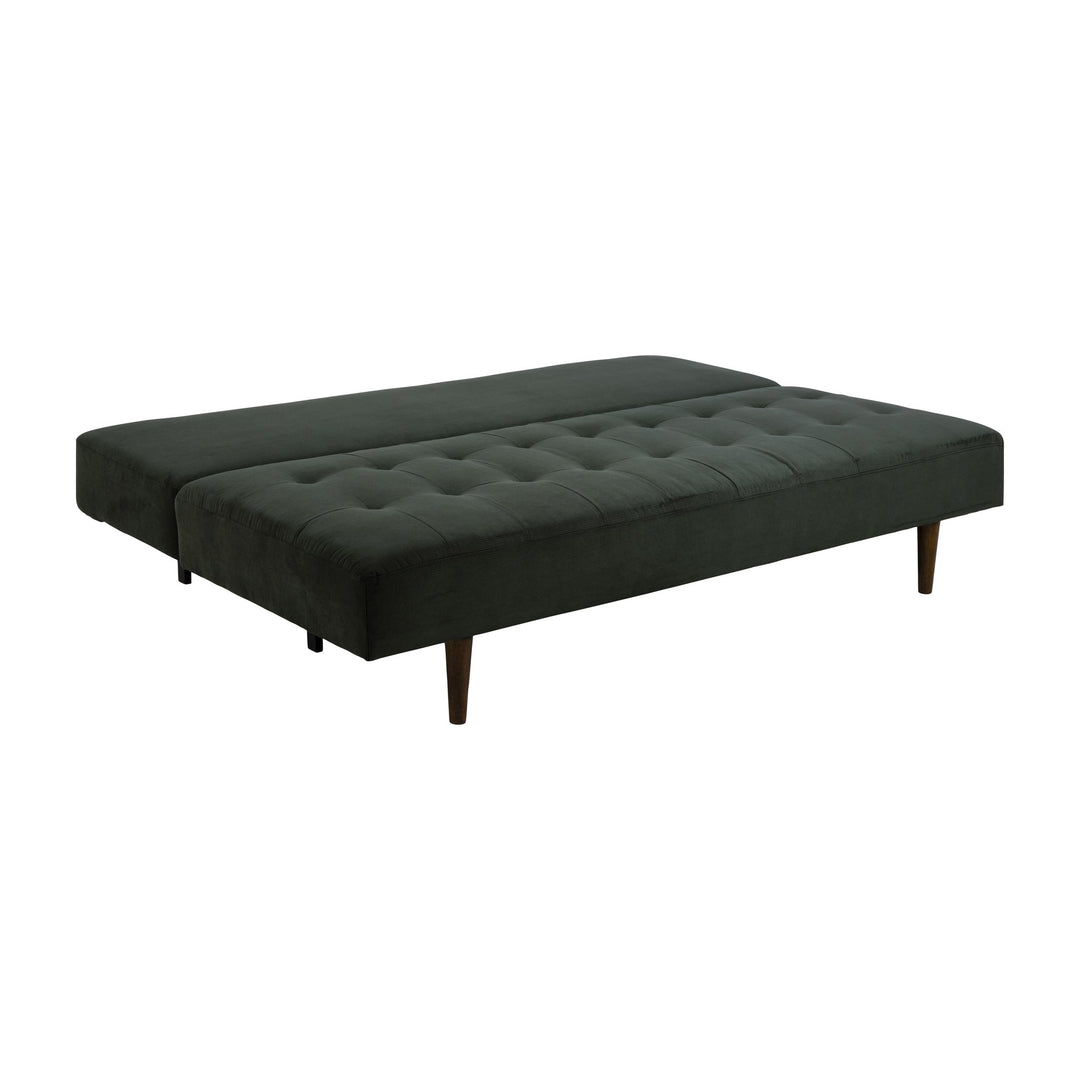 Blain sovesofa i mørkegrønn kordfløyel slått ut til seng, sett skrått