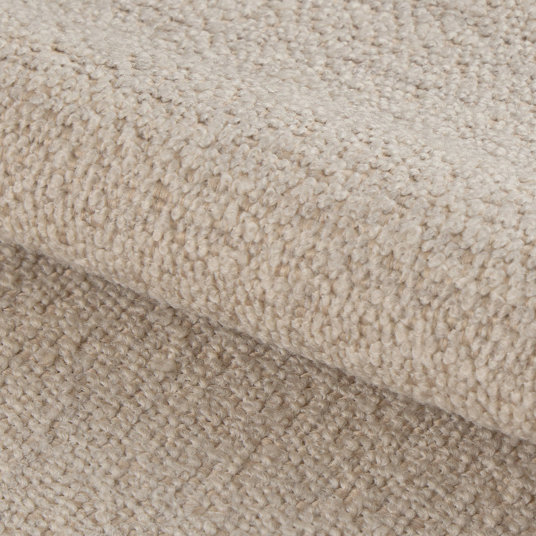 Rushville hjørnesofa i beige bouclé, nærbilde av den ull-aktige bouclé-tekstilen