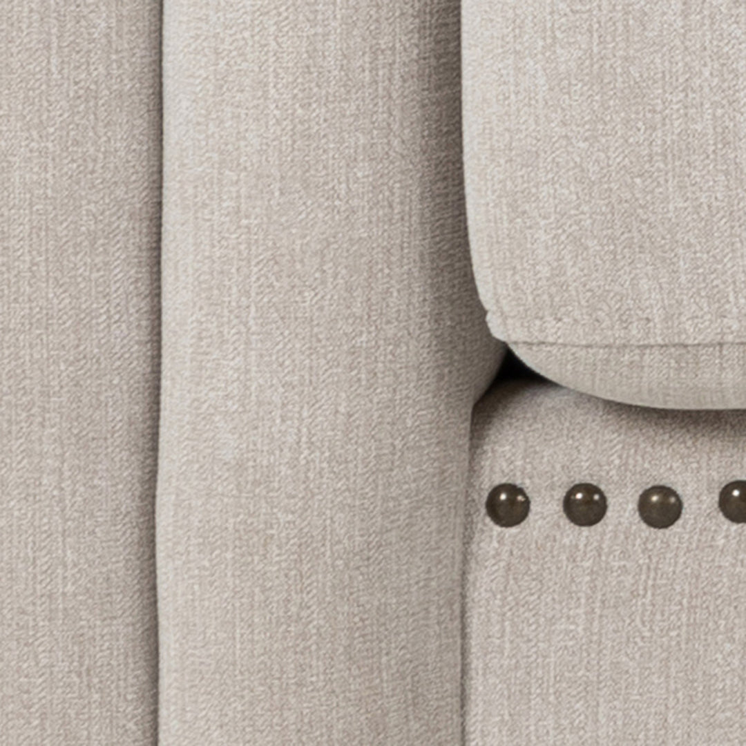 Charlietown sofa, nærbilde av beige linstoff med naglebånd langs kanten.