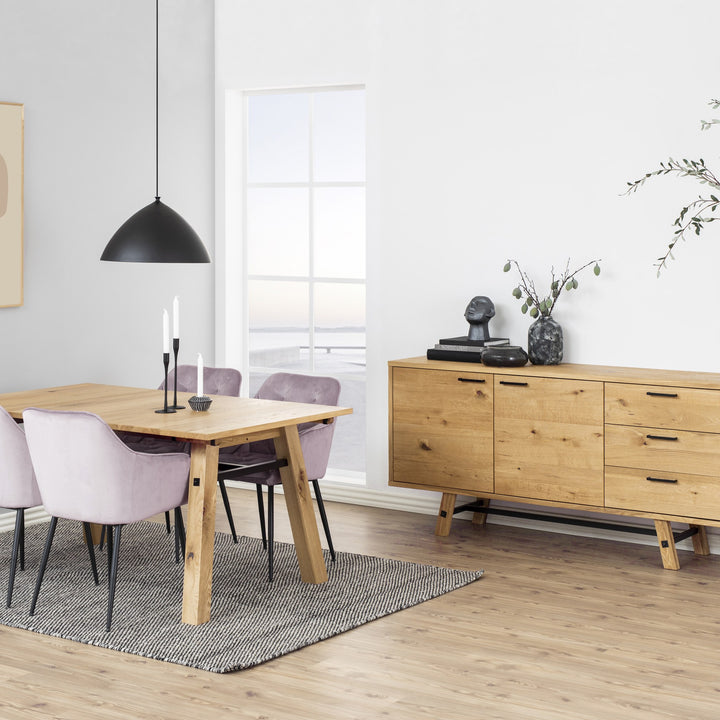 Brooke spisestol i lys rosa velur ved eikebord, med eikesideboard og svart pendel i lyst rom