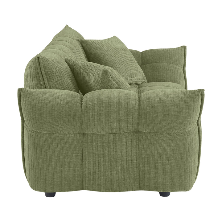 Marigold sofa i grønn kordfløyel, sidevisning av pløset rygg og rullet armlene