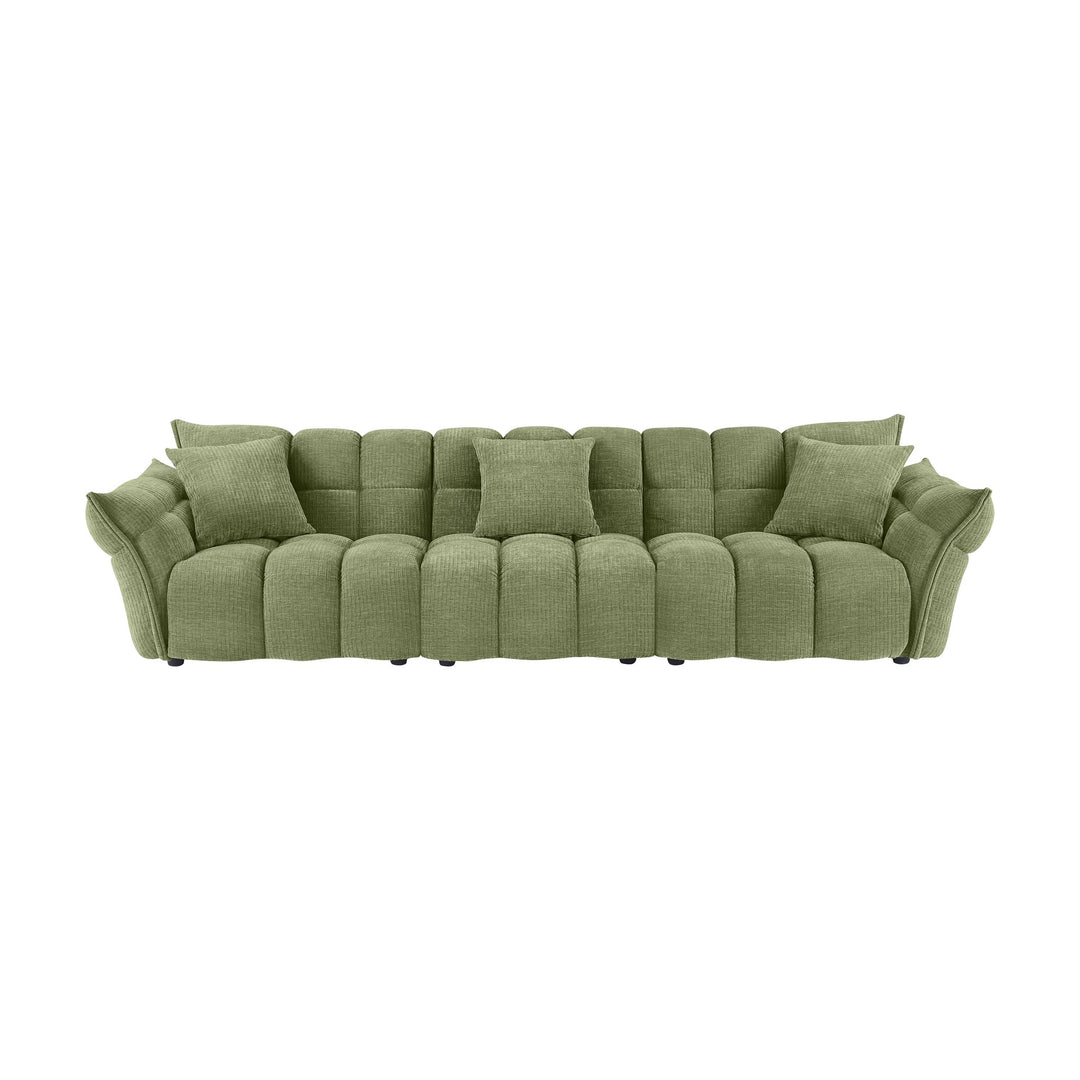 Marigold sofa i grønn med puffet, ribbet chenillestoff og mørke ben