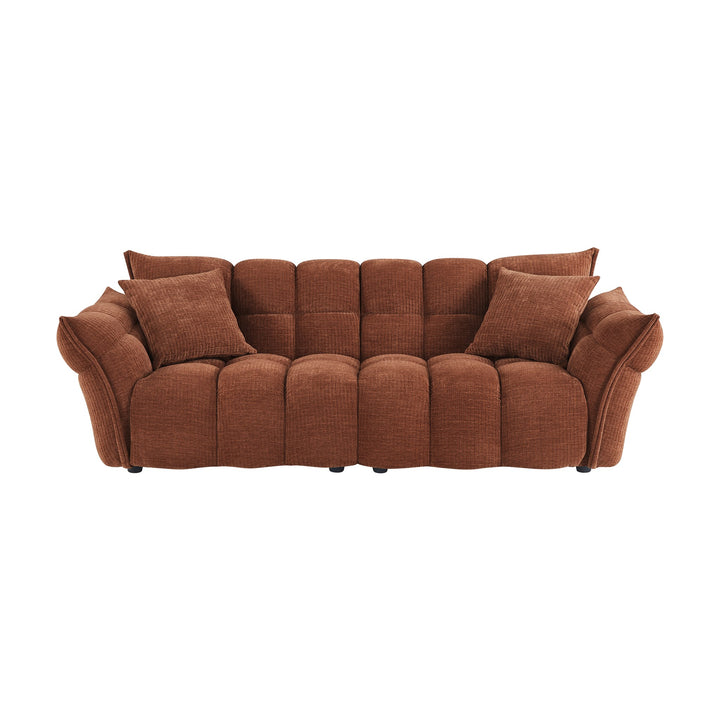 Marigold sofa i rust med puffet, ribbet chenillestoff og mørke ben
