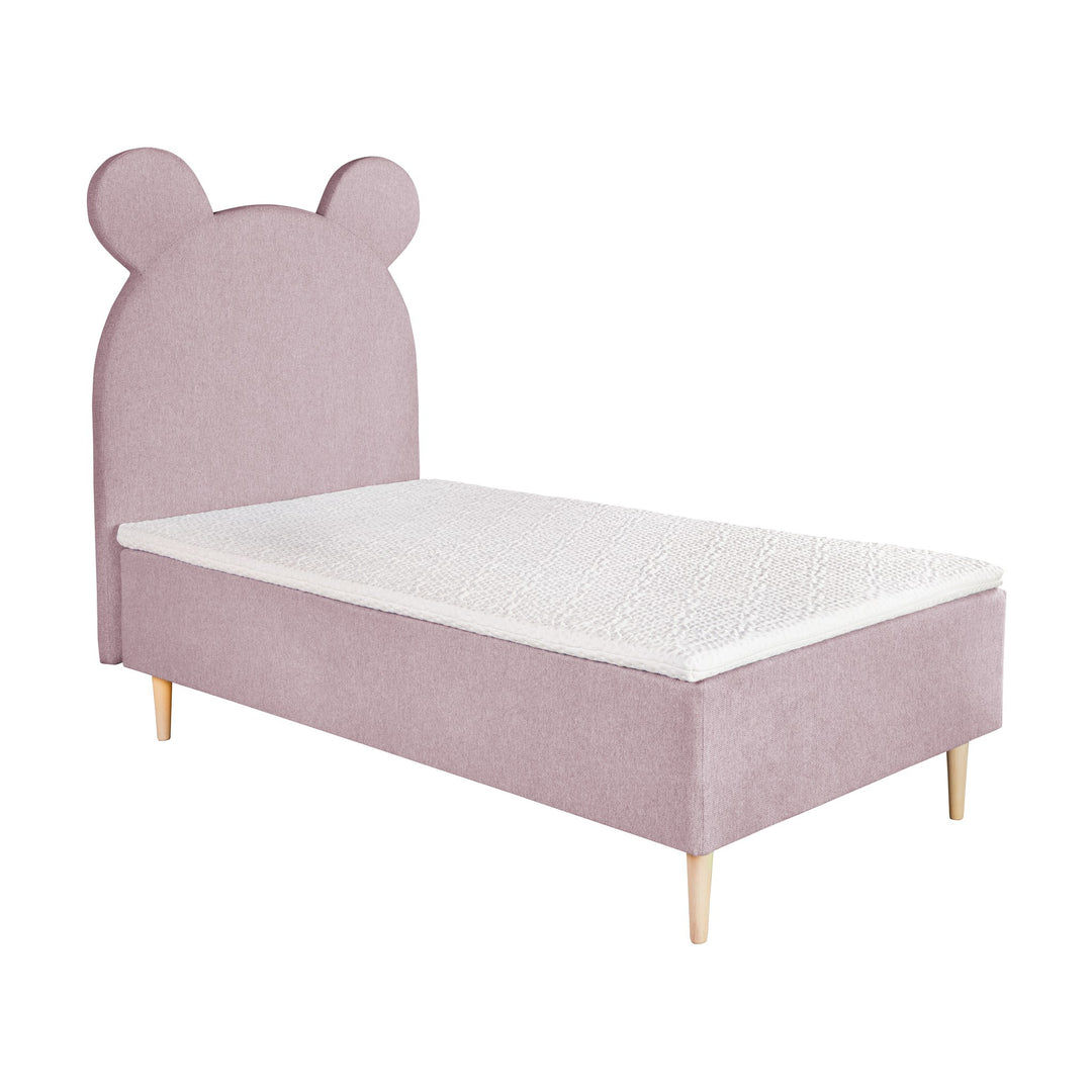 Asleep Teddy sengegavl i rosa med søte bjørneører, på barneseng med hvit madrass, sett skrått
