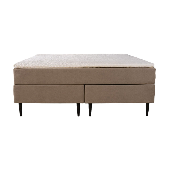 Asleep Venus kontinentalseng i beige, sett fra siden med hvit overmadrass og sorte ben