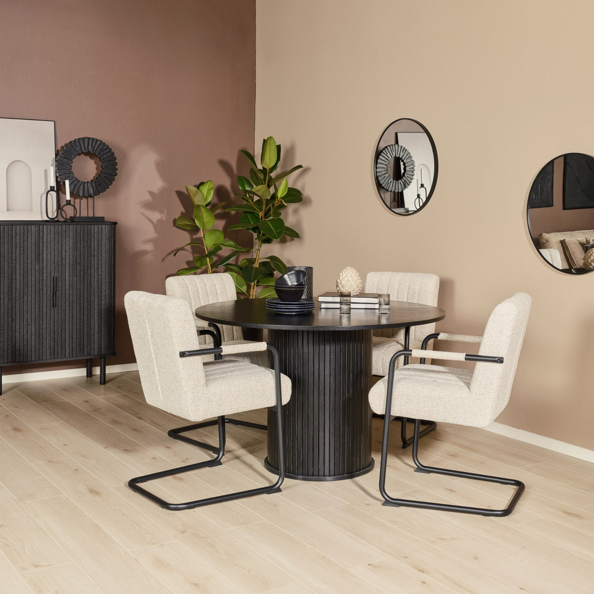 Trout spisestol i beige bouclé rundt sort spisebord, med plante og speil
