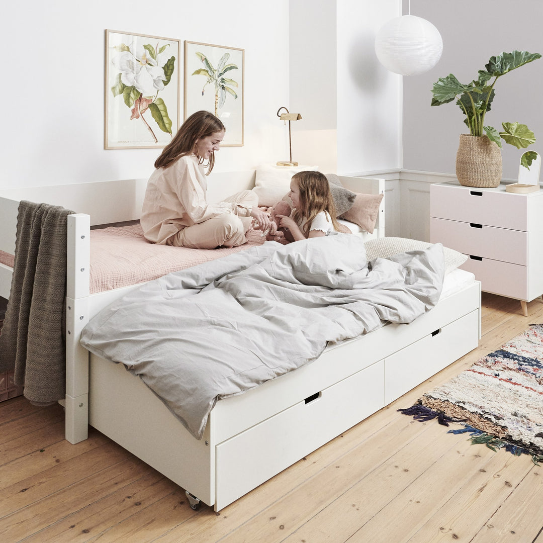 Manis-h Luna barneseng i snøhvit med uttrekksseng, i lyst barnerom med planter og bilder